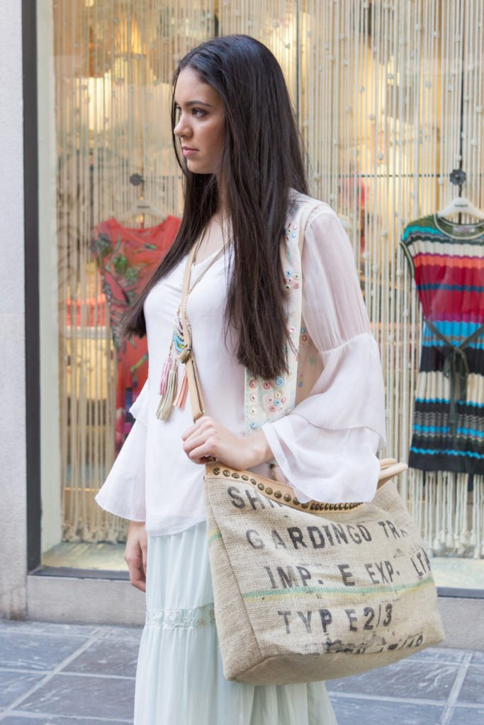 Girl in a shirt holding a handbag